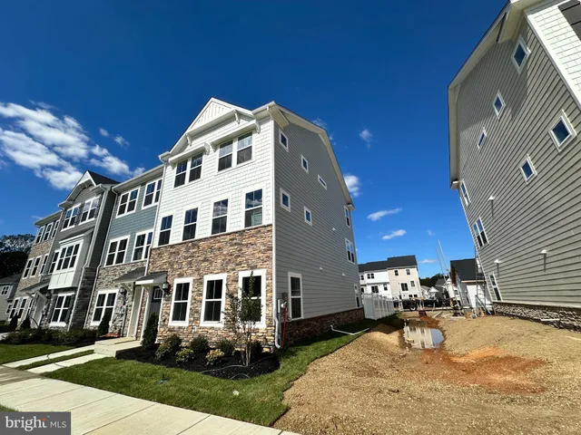 a building exterior with furniture and garden