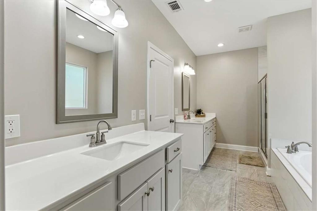 62 Joe Rowell Road Buchanan, GA 30113 - Photo 28 of 63 a bathroom with a sink double vanity granite tub shower and a mirror