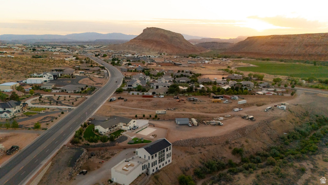 2591 East Washington Dam Road Washington, UT 84780 - Photo 60 of 67 Expansive high desert landscape featuring a residential community, a winding paved road, and distant mountain formations