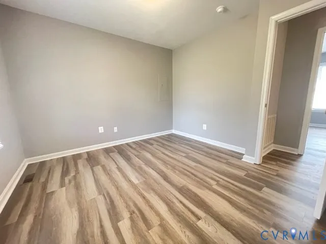 a view of room with window and wooden floor