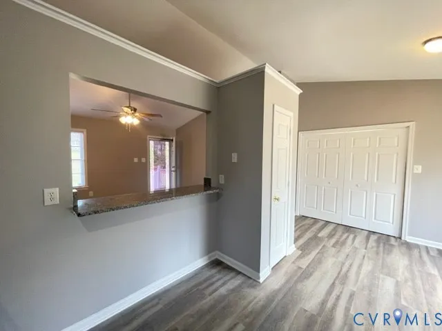 a view of a hallway with wooden floor