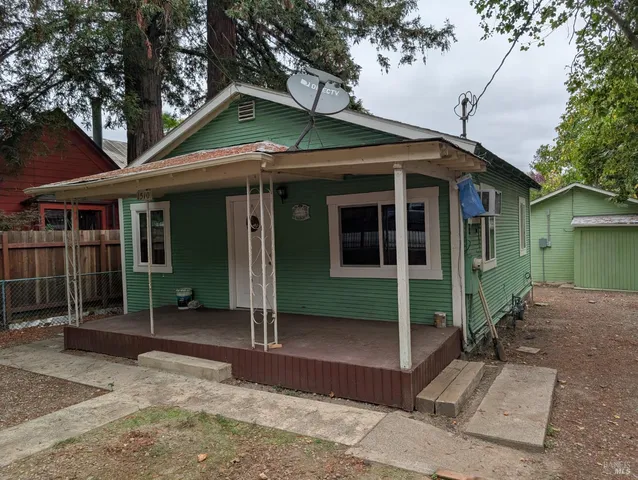 a front view of a house with a yard and porch