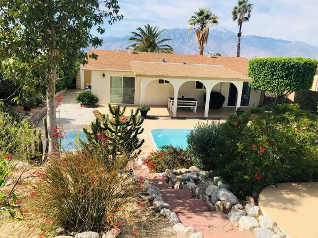 a front view of a house with garden