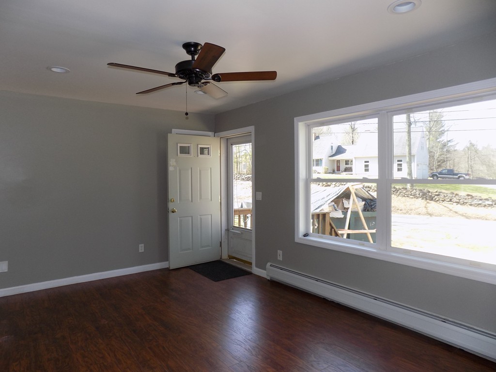 167 Union Road Wales, MA 01081 - Photo 3 of 16 a view of an empty room with wooden floor and a window