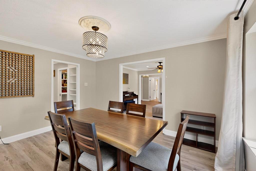 11717 Welch Road Dallas, TX 75229 - Photo 11 of 40 a view of a dining room with furniture and wooden floor