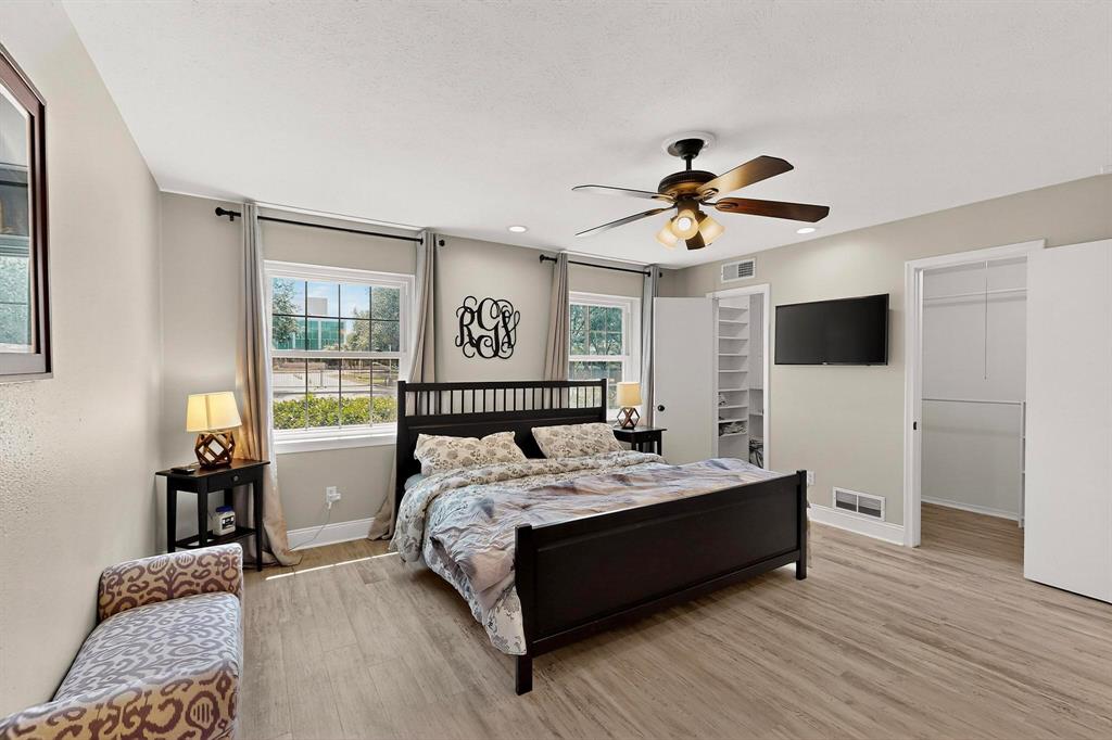 11717 Welch Road Dallas, TX 75229 - Photo 18 of 40 a bed sitting in a bedroom and a flat screen tv