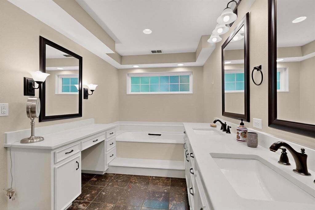 11717 Welch Road Dallas, TX 75229 - Photo 19 of 40 a bathroom with a tub sink and mirror