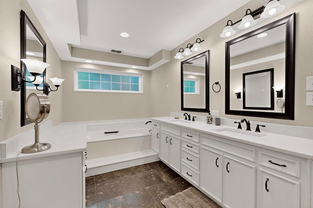 11717 Welch Road Dallas, TX 75229 - Photo 20 of 40 a bathroom with a double vanity sink mirror and bathtub