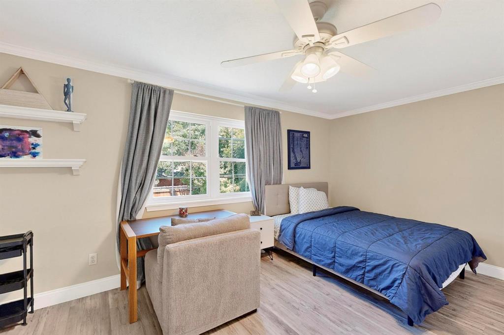 11717 Welch Road Dallas, TX 75229 - Photo 22 of 40 a bedroom with a bed and a window