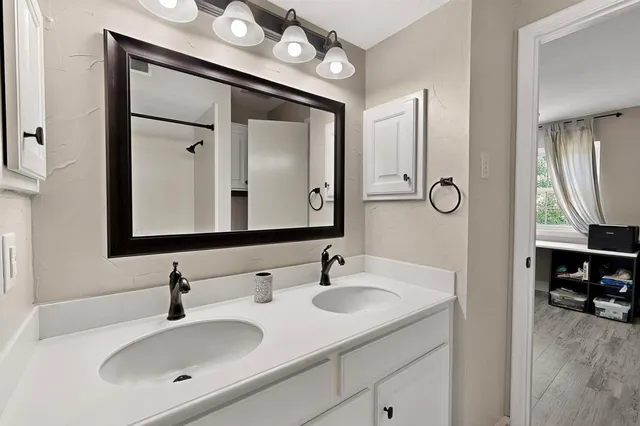 a bathroom with a sink vanity and a mirror