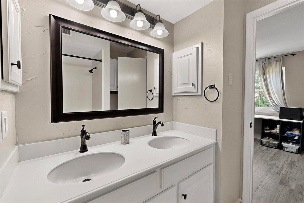 11717 Welch Road Dallas, TX 75229 - Photo 28 of 40 a bathroom with a sink vanity and a mirror