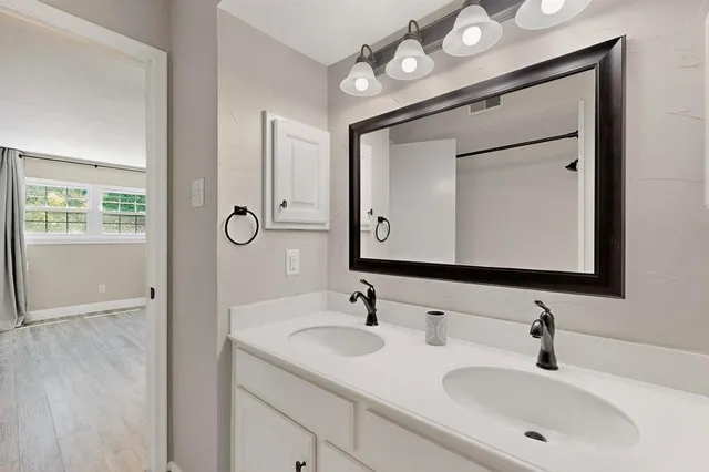 a bathroom with 2 sink and a mirror
