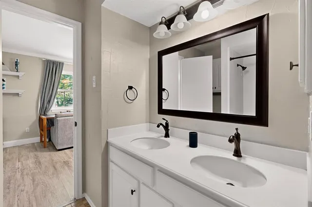 a bathroom with a sink a mirror and a shower