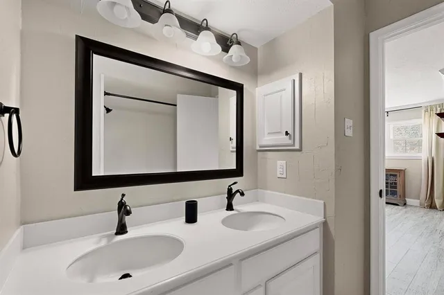 a bathroom with 2 sink and a mirror