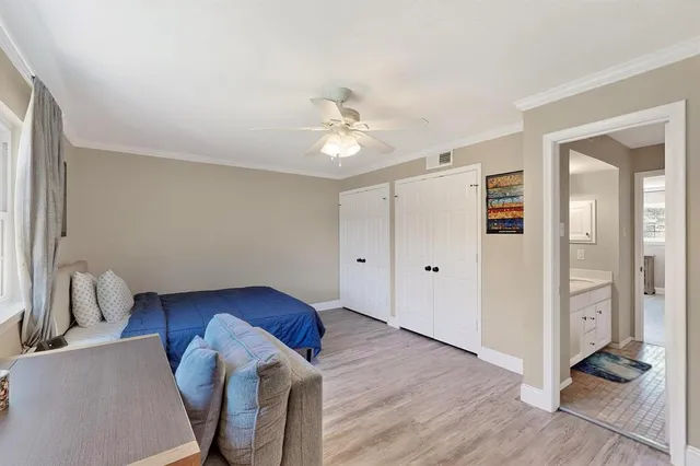 a living room with wooden floors and ceiling fan