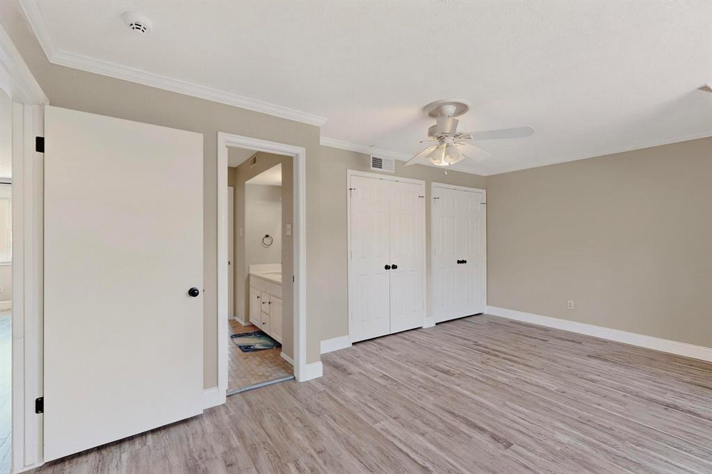 11717 Welch Road Dallas, TX 75229 - Photo 36 of 40 a view of an empty room with wooden floor and closet
