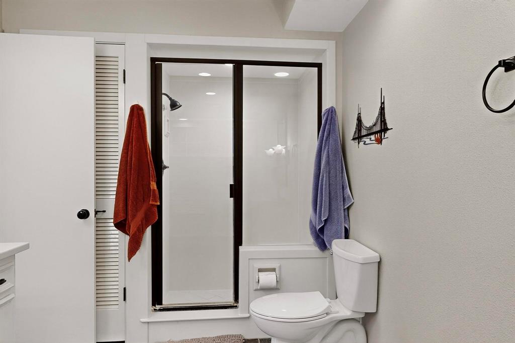 11717 Welch Road Dallas, TX 75229 - Photo 37 of 40 a bathroom with a toilet and a shower