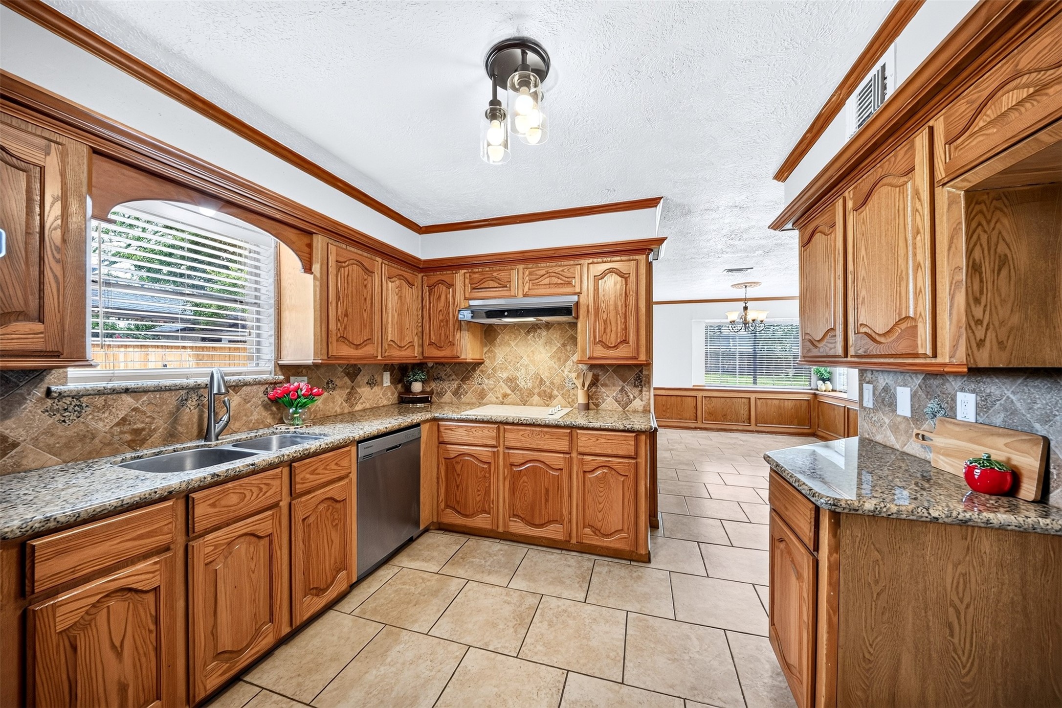 6507 Spring Leaf Drive Spring, TX 77379 - Photo 11 of 50 Cant miss the bright window over the sink that fills the kitchen with natural light, all while offering a wide-open view into the expansive dining and living areas.