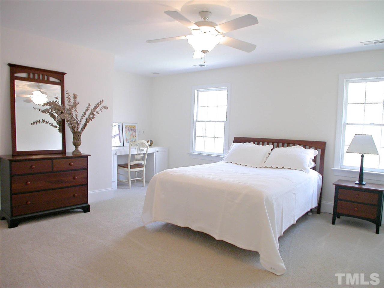 7017 Millstone Ridge Court Raleigh, NC 27614 - Photo 14 of 25 a bedroom with a bed and a chandelier