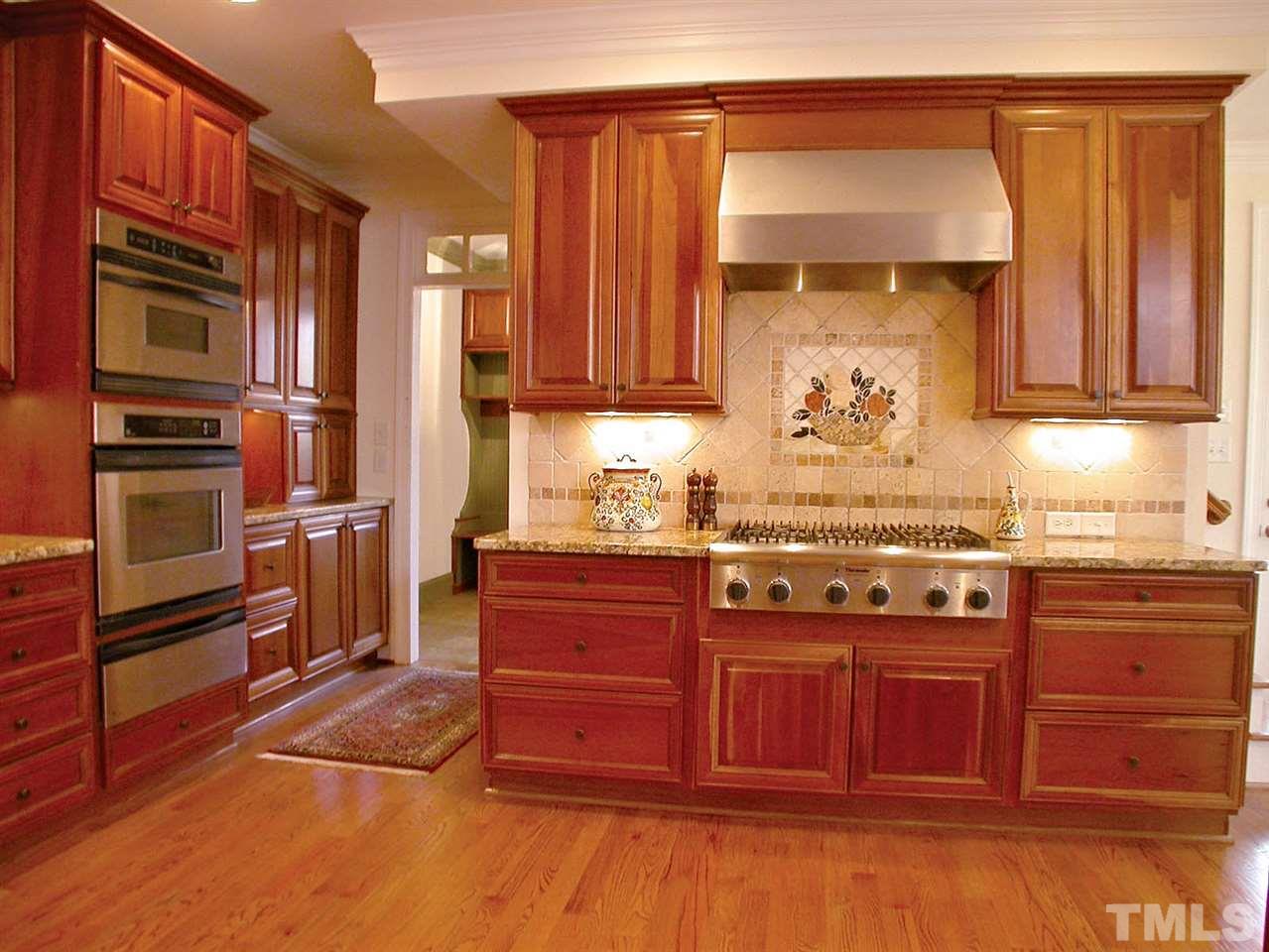 7017 Millstone Ridge Court Raleigh, NC 27614 - Photo 3 of 25 a kitchen with stainless steel appliances granite countertop a stove and a refrigerator