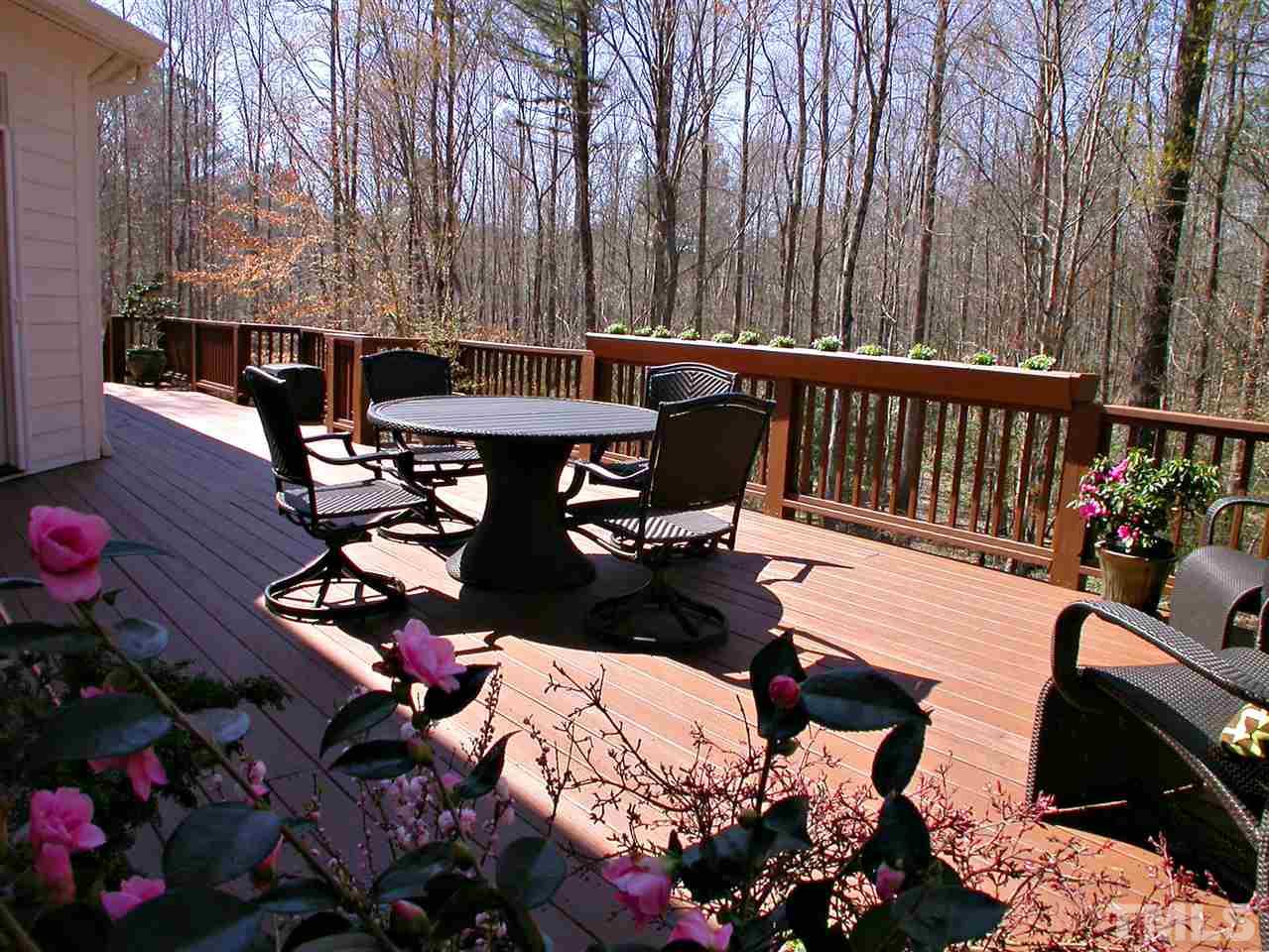 7017 Millstone Ridge Court Raleigh, NC 27614 - Photo 21 of 25 a view of a patio with table and chairs potted plants
