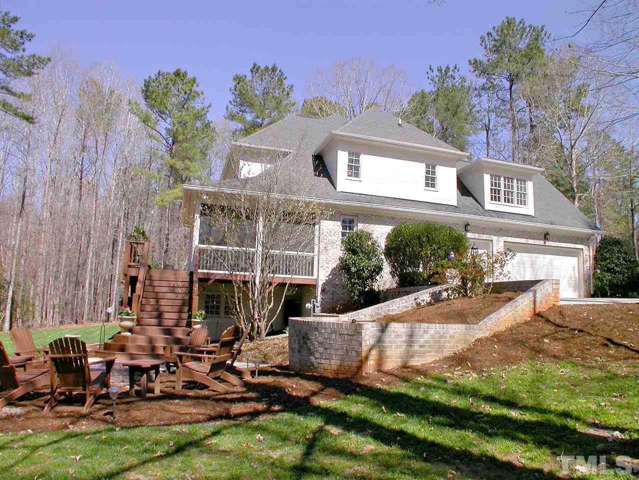 7017 Millstone Ridge Court Raleigh, NC 27614 - Photo 23 of 25 a view of a chair and table in backyard