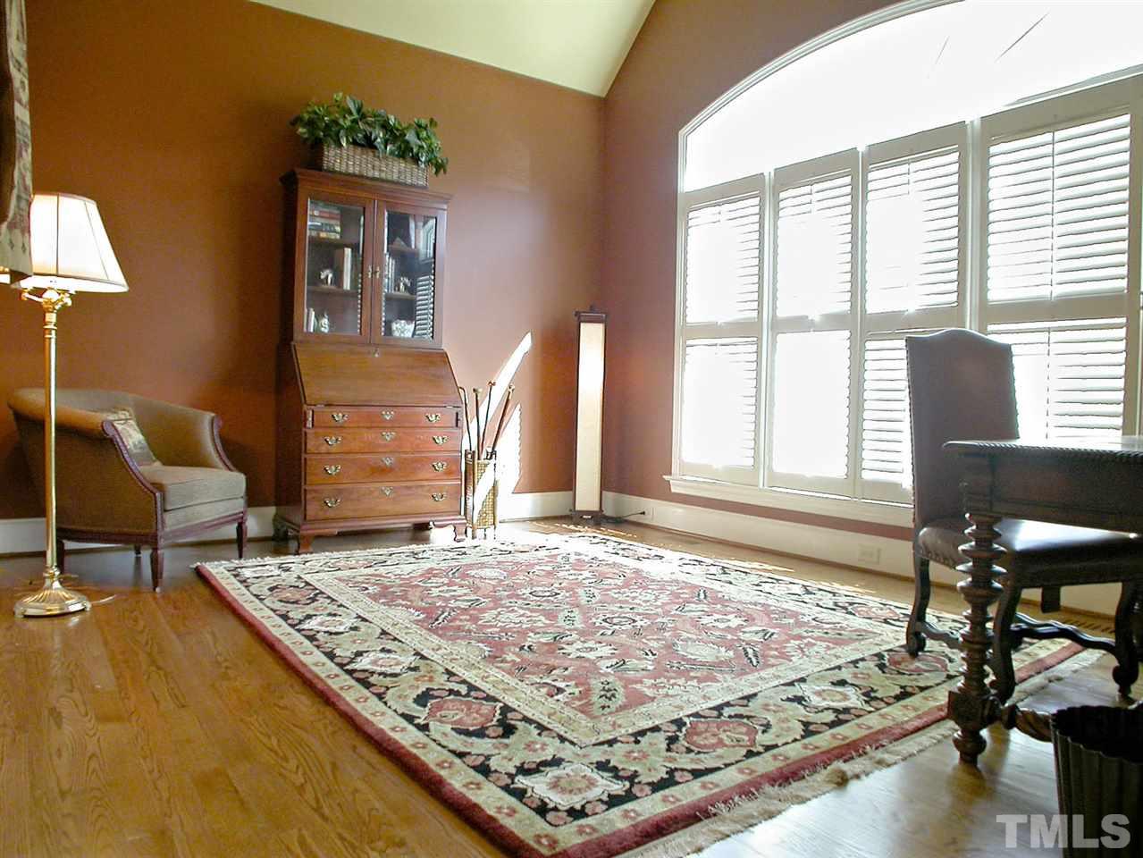 7017 Millstone Ridge Court Raleigh, NC 27614 - Photo 10 of 25 a bedroom with a bed and wooden floor