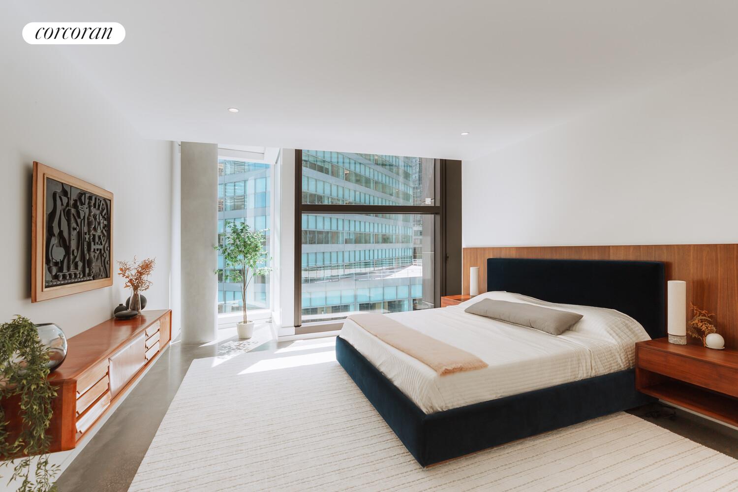 100 East 53rd Street, Unit 5C Manhattan, NY 10022 - Photo 8 of 23 a bedroom with a large bed and a large window