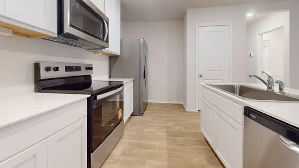 a kitchen with stainless steel appliances granite countertop a sink and a stove