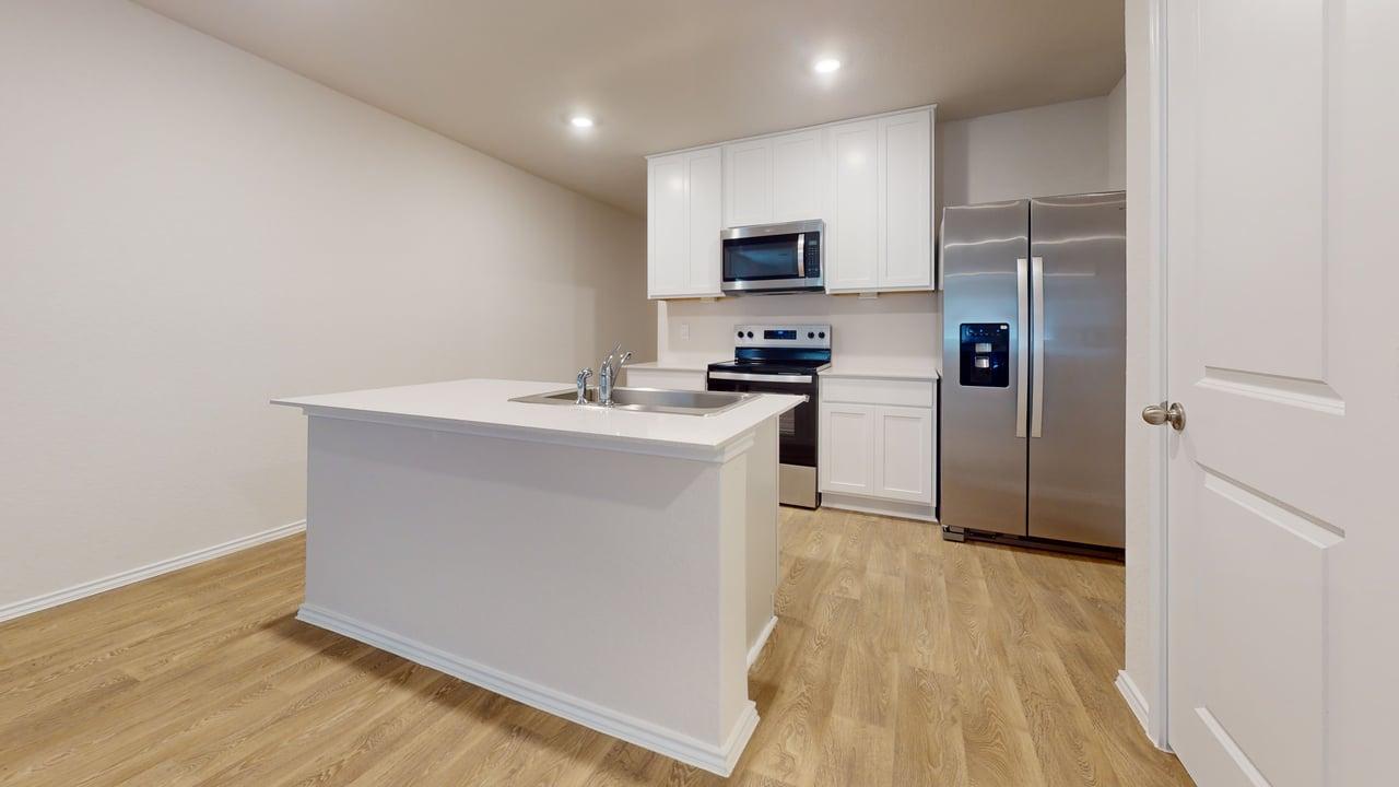 914 Indian Way Seguin, TX 78155 - Photo 6 of 18 a kitchen with a refrigerator a stove top oven and wooden floor