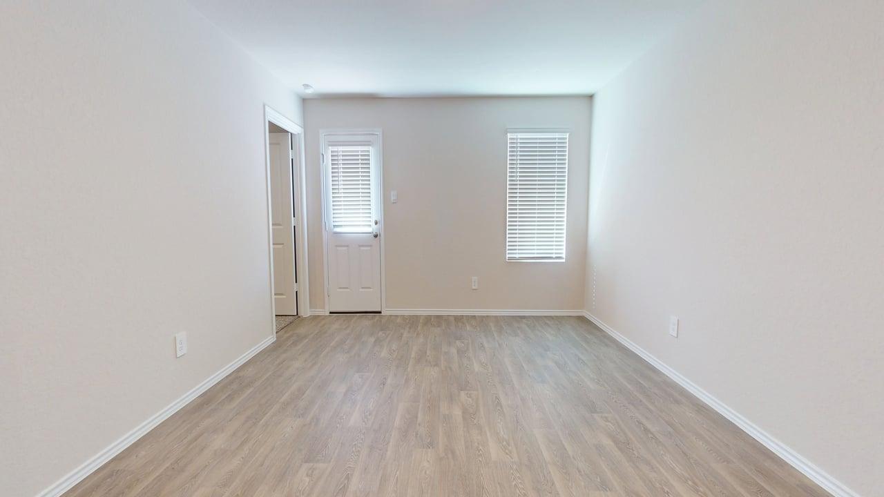 914 Indian Way Seguin, TX 78155 - Photo 7 of 18 an empty room with wooden floor and windows