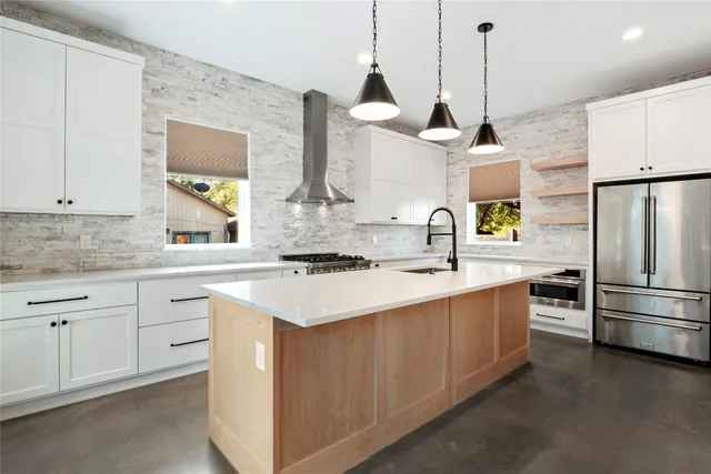 a kitchen with stainless steel appliances a sink stove and refrigerator