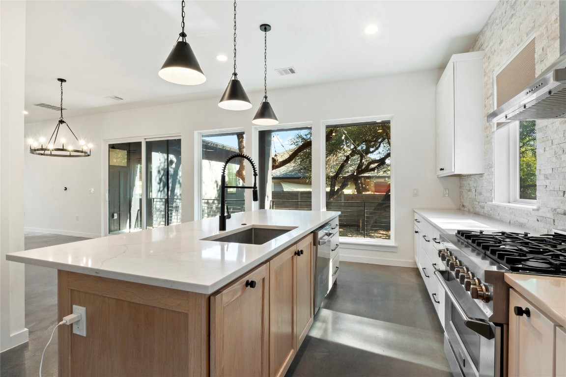 18205 Fair Lane Jonestown, TX 78645 - Photo 13 of 40 a kitchen with a stove and a sink