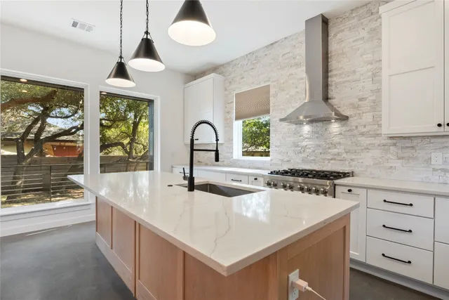 a kitchen with sink stove and cabinets