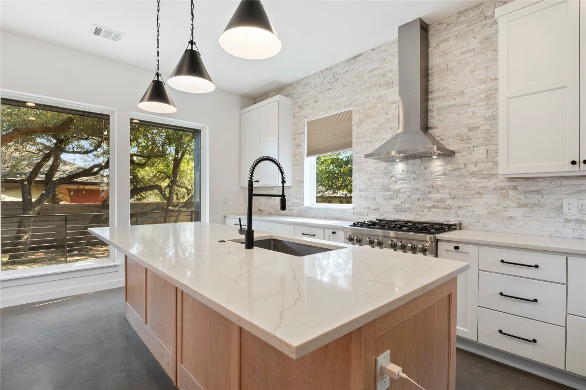 18205 Fair Lane Jonestown, TX 78645 - Photo 14 of 40 a kitchen with sink stove and cabinets