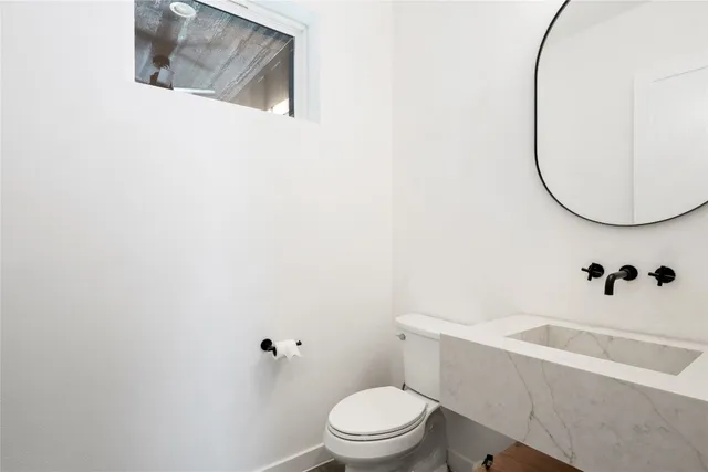 a white toilet sitting next to a white tub and a shower