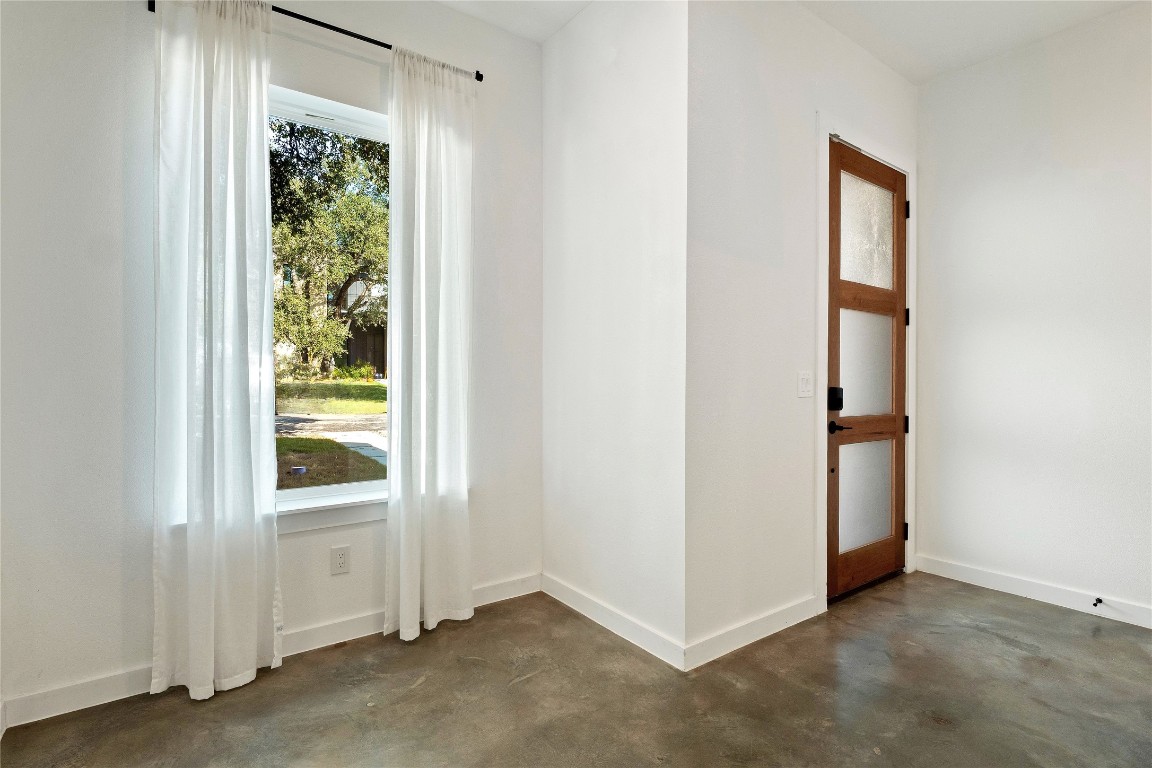 18205 Fair Lane Jonestown, TX 78645 - Photo 4 of 40 an empty room with windows and closet