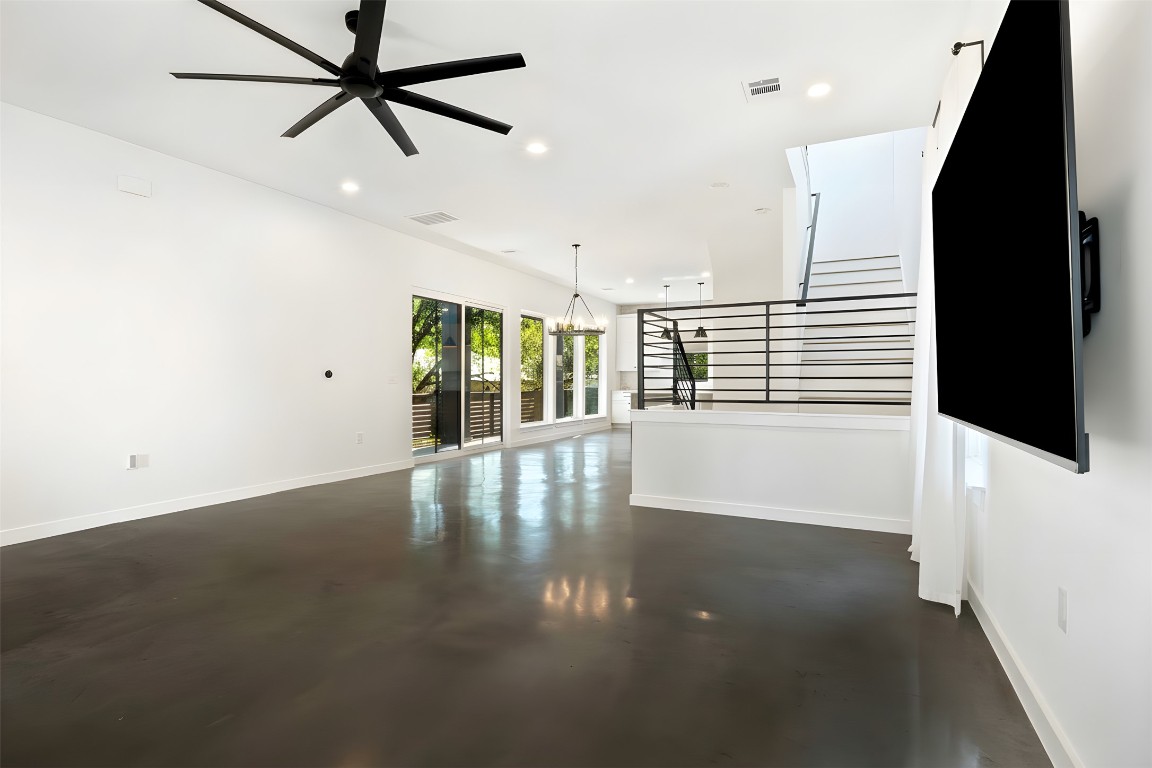 18205 Fair Lane Jonestown, TX 78645 - Photo 8 of 40 an empty room with windows and ceiling fan