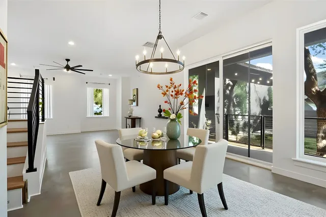 a dining room with furniture a chandelier and wooden floor