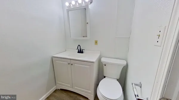 a white toilet sitting next to a bathroom sink