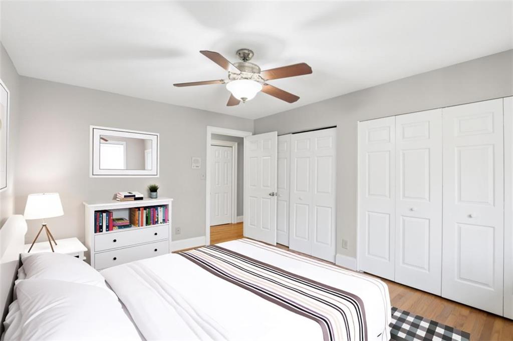 3959 Randall Mill Road Northwest Atlanta, GA 30327 - Photo 12 of 29 a bedroom with a large bed and a chandelier