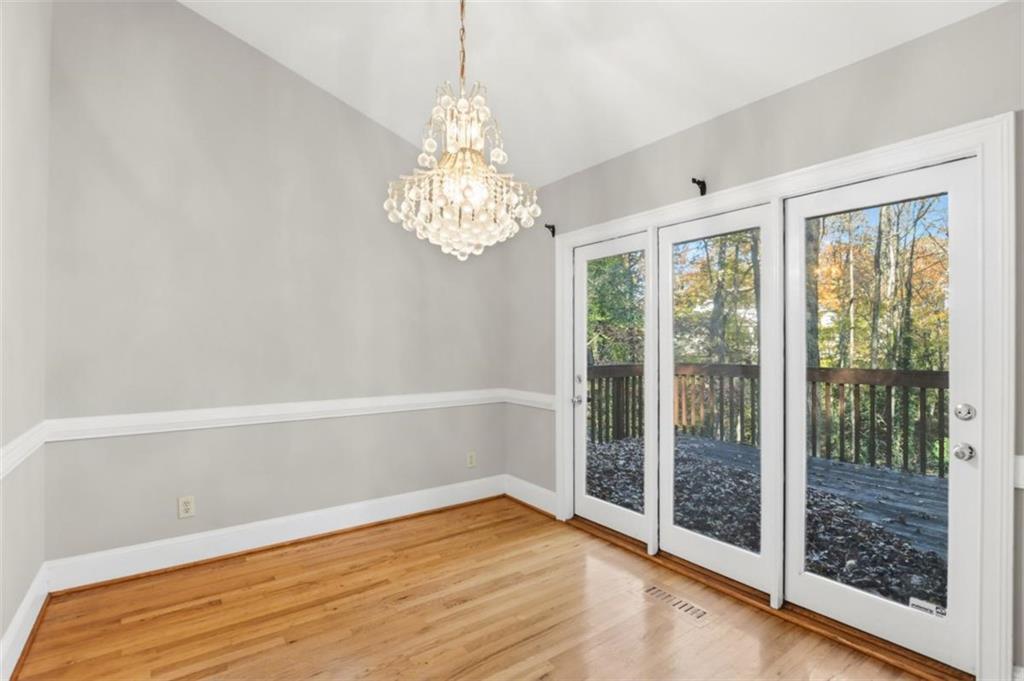 3959 Randall Mill Road Northwest Atlanta, GA 30327 - Photo 8 of 29 a view of empty room with wooden floor and fan