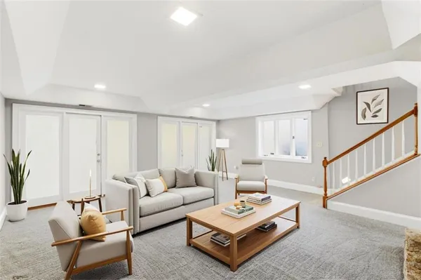 a living room with furniture and a potted plant