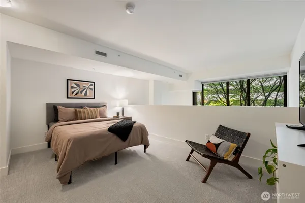 a bedroom with a bed and a chair
