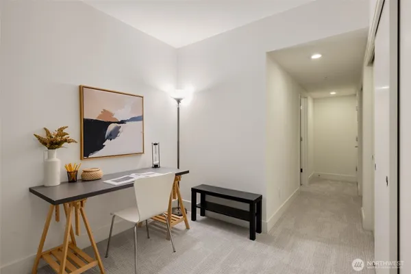 a view of a hallway with workspace and a mirror