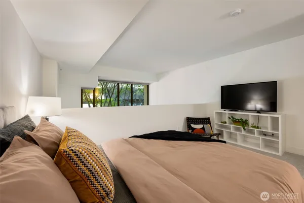 a bedroom with a bed and a flat screen tv