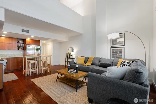 a living room with furniture and a wooden floor