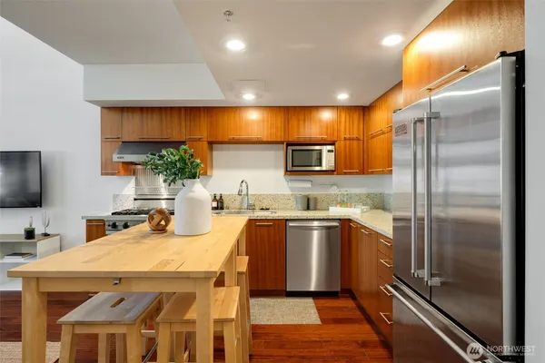 a kitchen with a sink appliances and cabinets