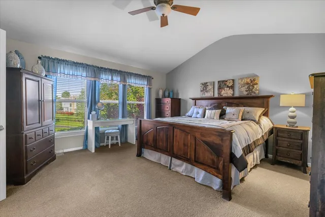 a spacious bedroom with a bed and a chandelier