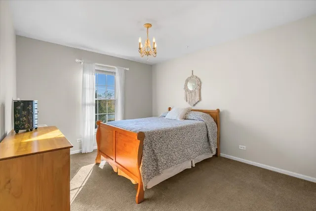 a bed room with a bed and a chandelier